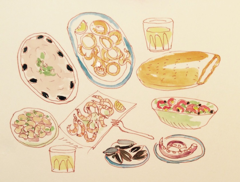 A feast of lagana bread, octopus, calamari, shrimp, mussels, beans, olives, tarama and wine
